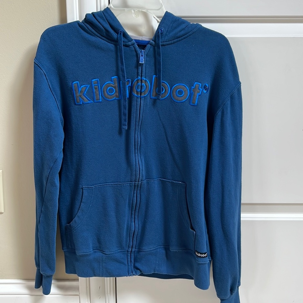 Kidrobot zip hoodie in royal blue with grey lined hood.